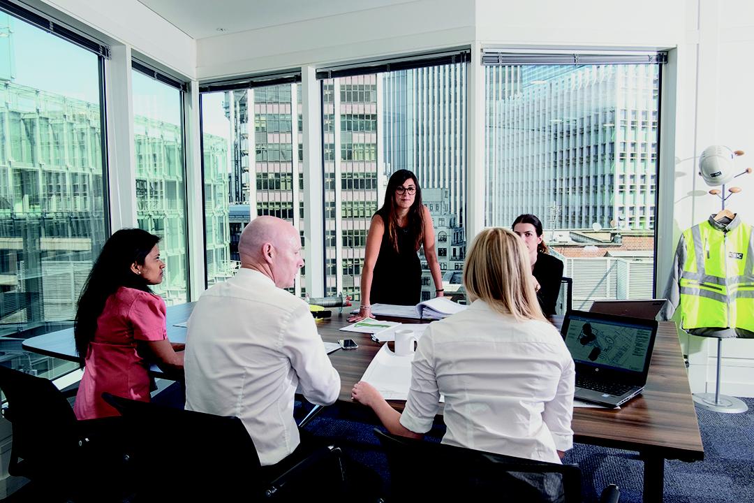 people at around a table in a modern looking office