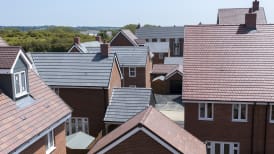 a plt of new build homes with red and grey roofs