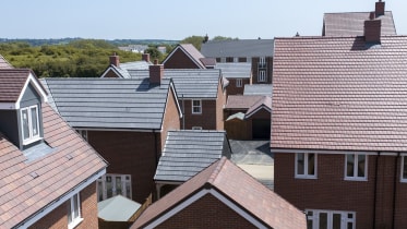 a plt of new build homes with red and grey roofs