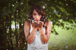 Woman blowing glitters on her hands, © Oleg Magni