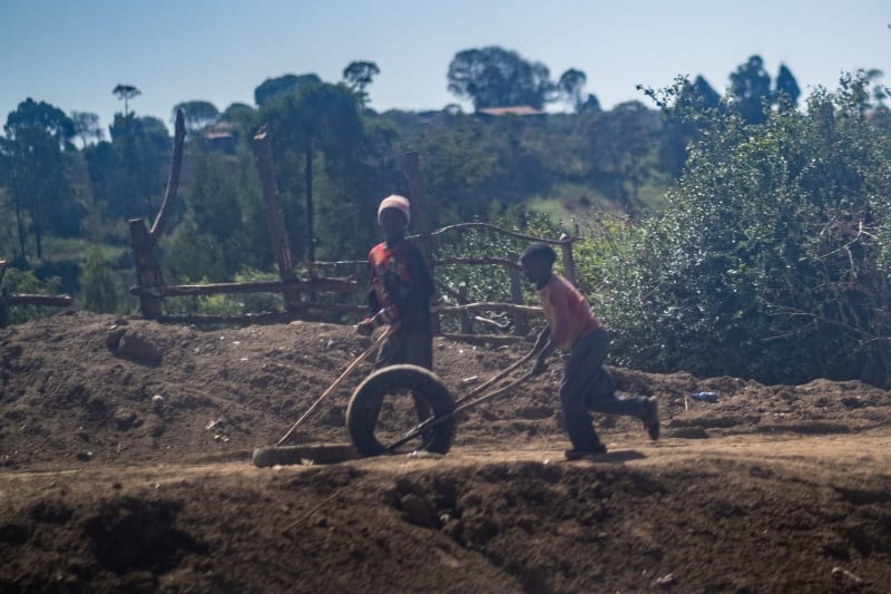 Children propeling a tire