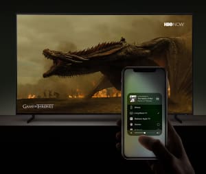An iPhone streaming Game of Thrones to a TV with AirPlay 2