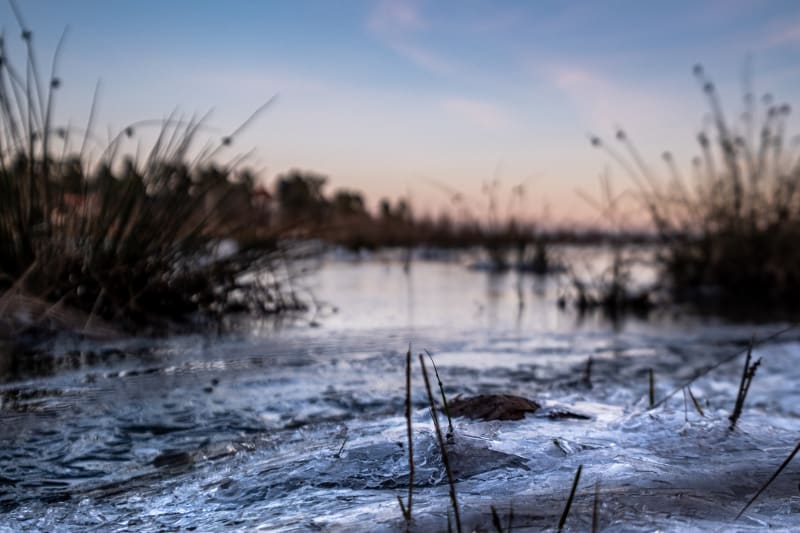 Photo taken on the shore of the calm sea, with frozen water
