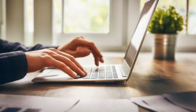 Person typing at a laptop