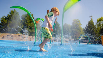 Child having fun in a splash pad
