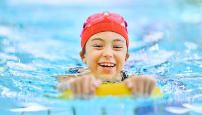 A happy child swimming.