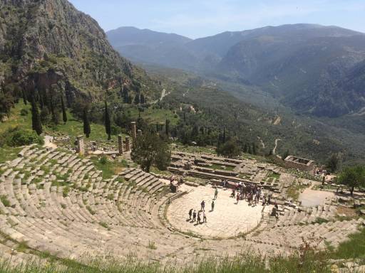 Ancient amphitheatre with mountains in the background