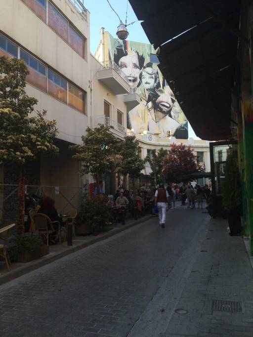 A street with a giant mural in the background