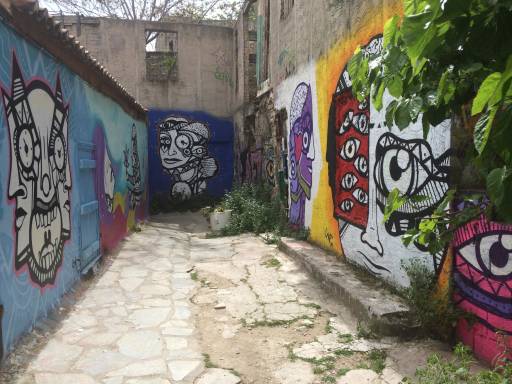 A worn-down alleyway brought to life with vibrant street art