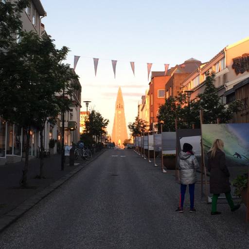 Church steeple at the end of a street in what looks like broad daylight