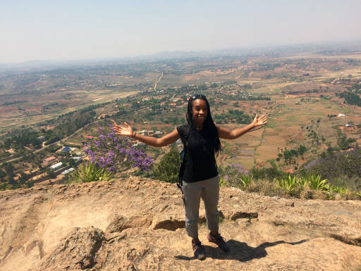 Me standing by a cliff edge with the vast expansive view in the background