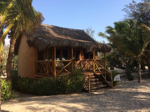 a raised thatched house on the beach