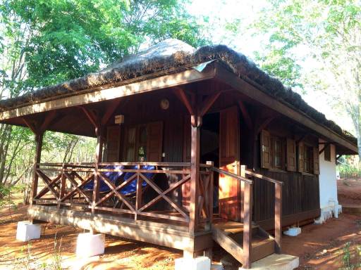 an elevated cabin with a thatched roof