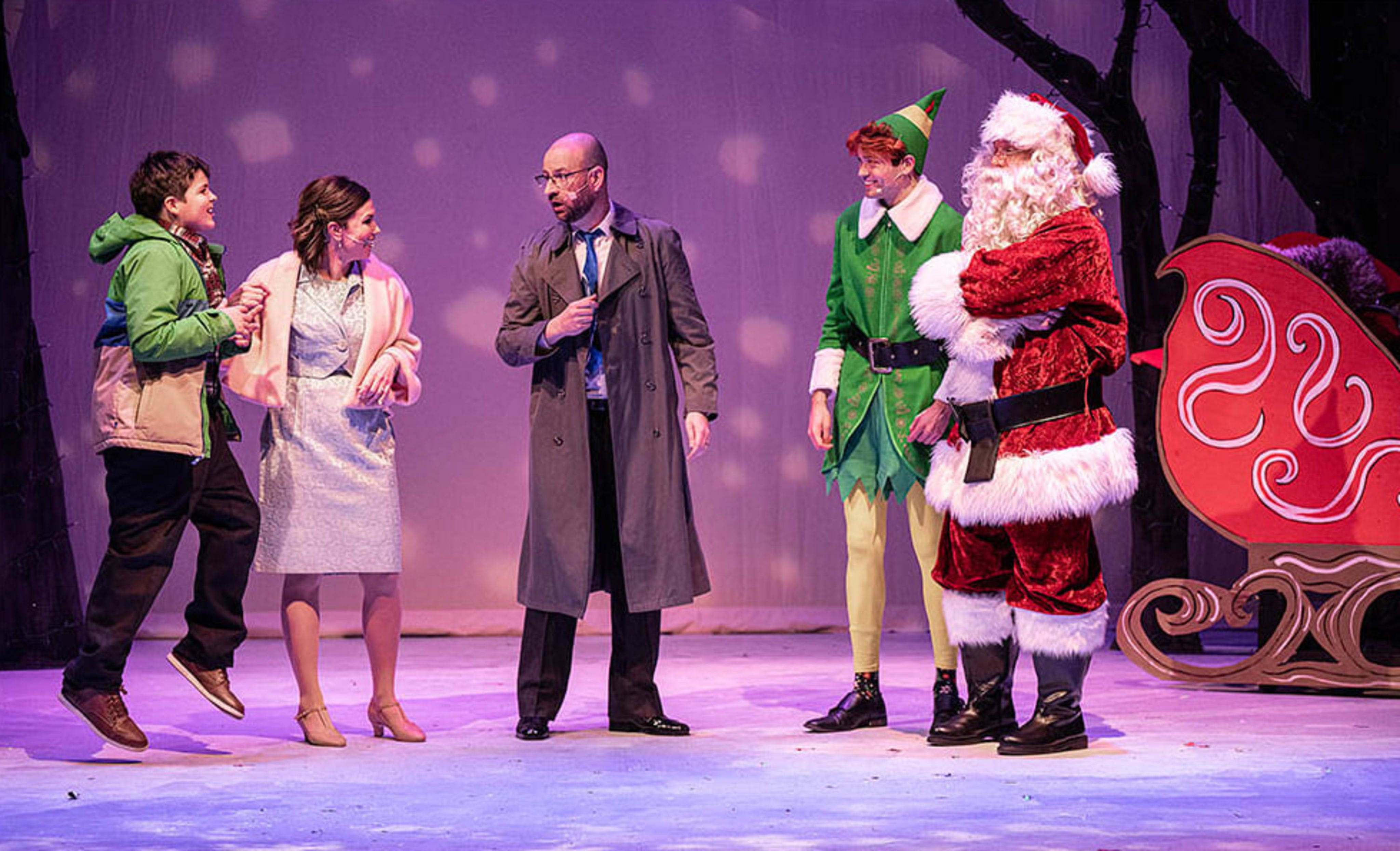 Nick as Buddy in Elf, with the Hobbs family and Santa