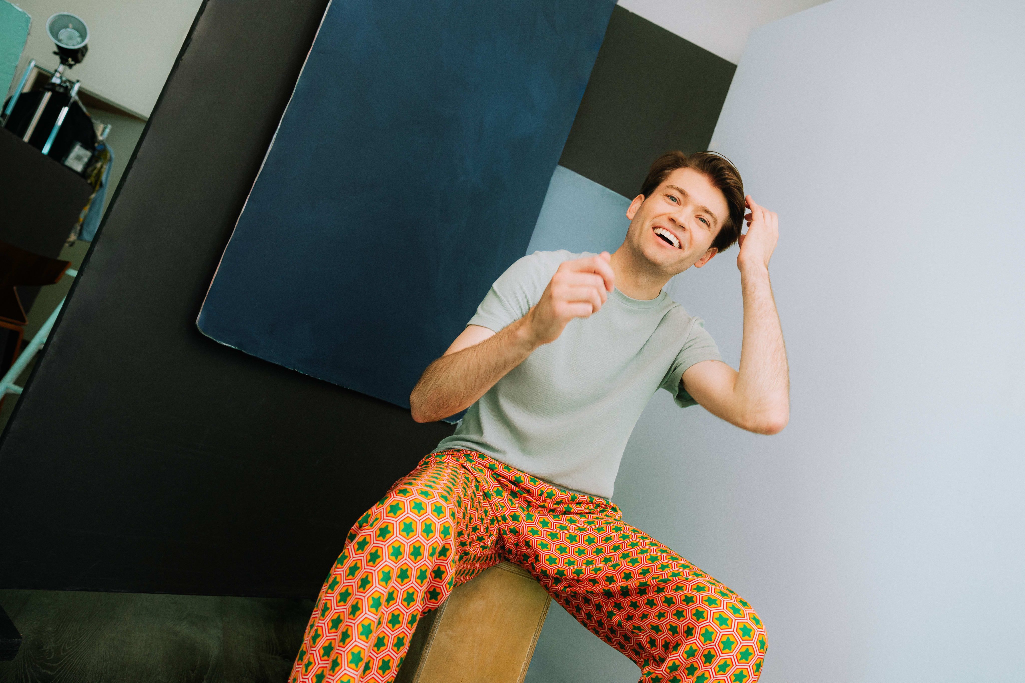 Nick Xitco, sitting on a box, laughing