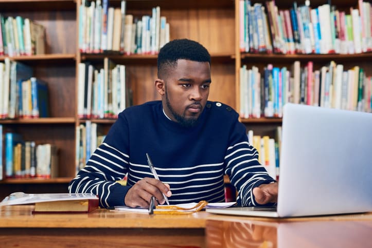 University Student working on his laptop in the university