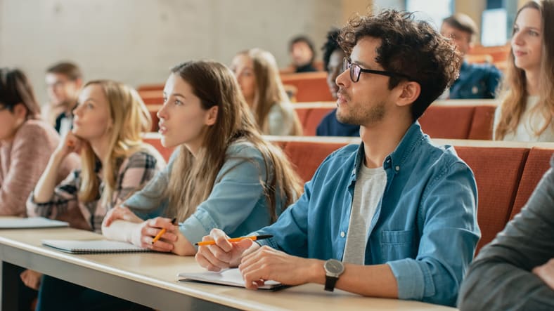 Students taking notes at a university lecture