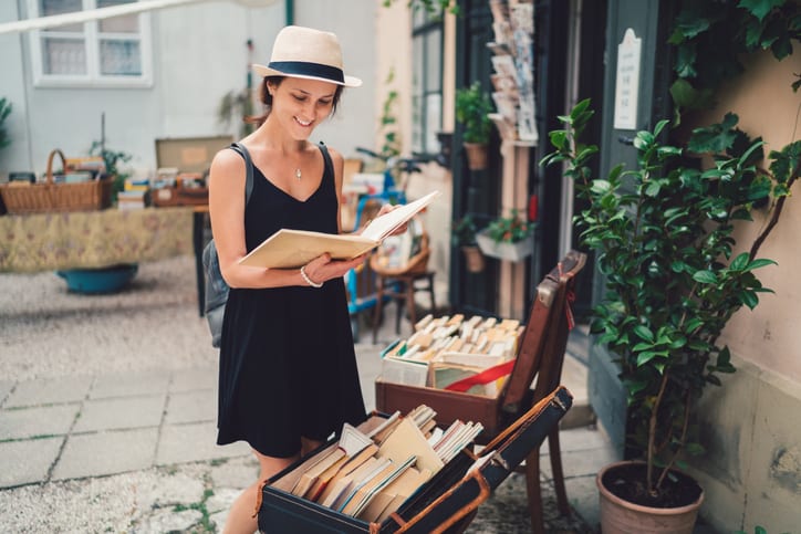 young woman looking at books