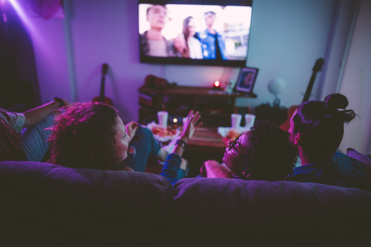 Students watching tv and chatting 