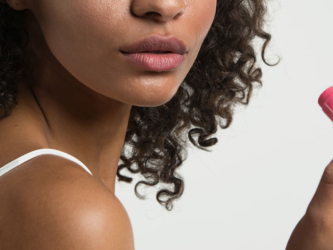 Woman Holding Pink Beauty Product Close Up Portrait