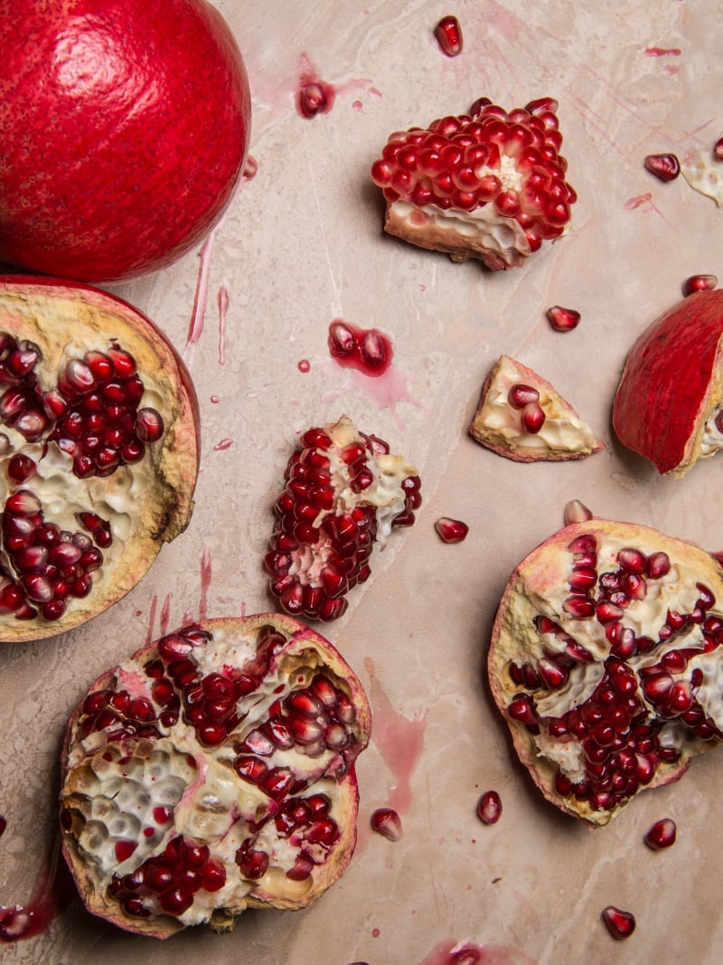 Fresh Pomegranate Ruby Red Seeds Scattered Parchment