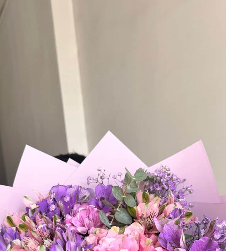 Assorted roses bouquet with purple wrapping view 2