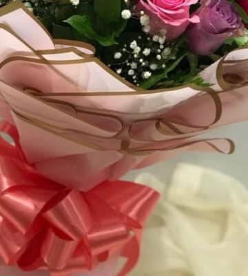 Mixed flowers bouquet with crocus leaves wrapped in pink paper N view 3