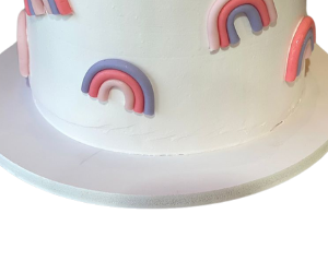 White cake with a rainbow and a white teddy bear view 3