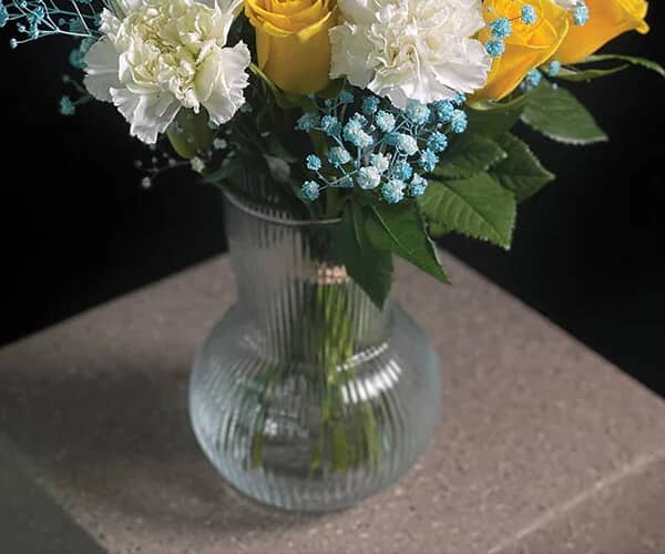 A vase of simple white and blue roses view 3
