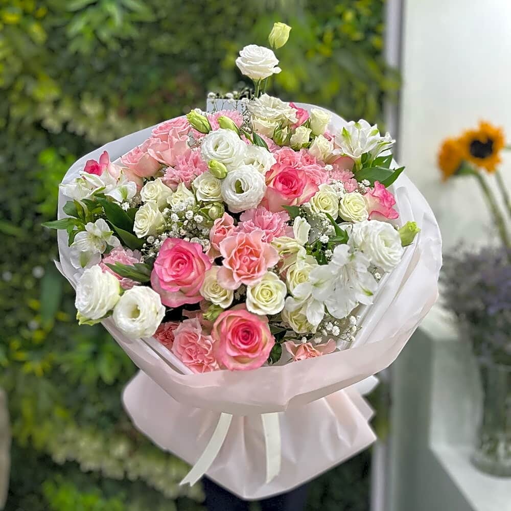 A pink rose bouquet with a purple wrapper view 1