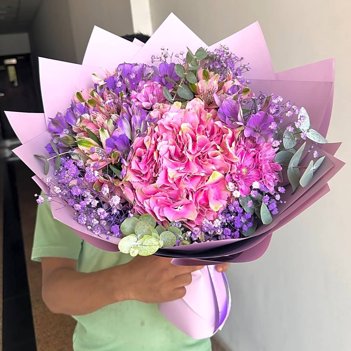 Assorted roses bouquet with purple wrapping view 1