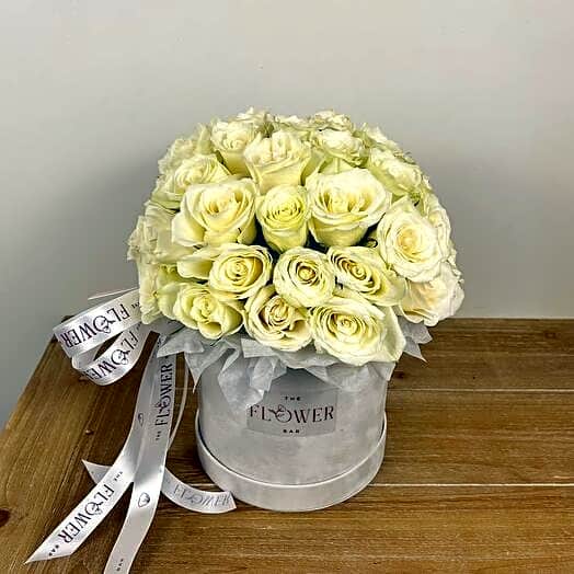 A box of white roses view 1