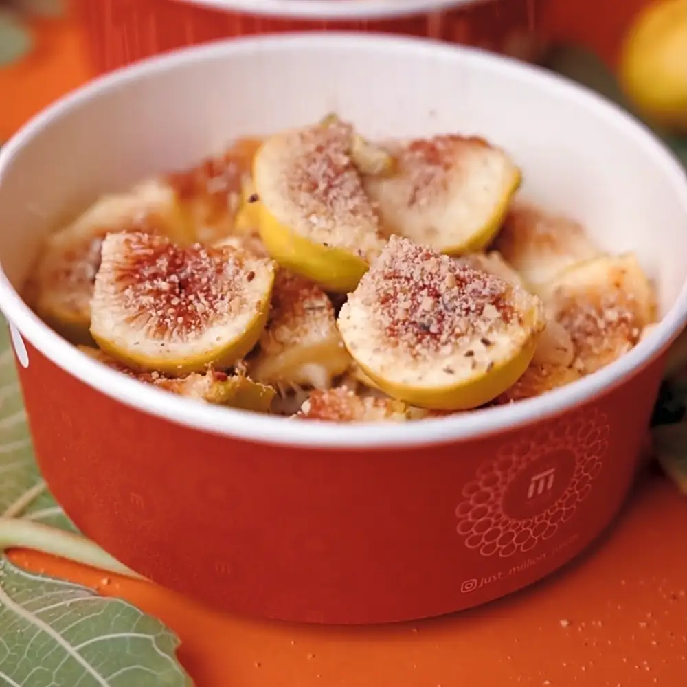 A box of figs with fresh walnuts