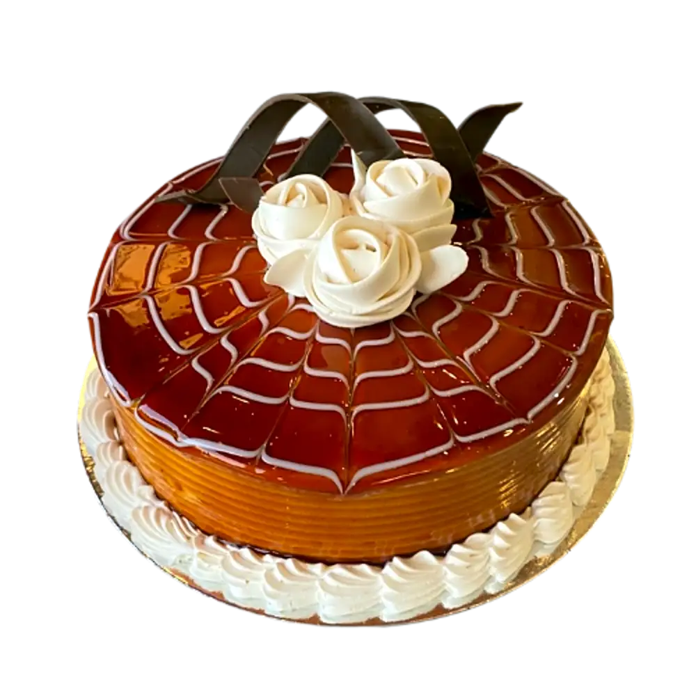 Chocolate and caramel cake decorated with cream