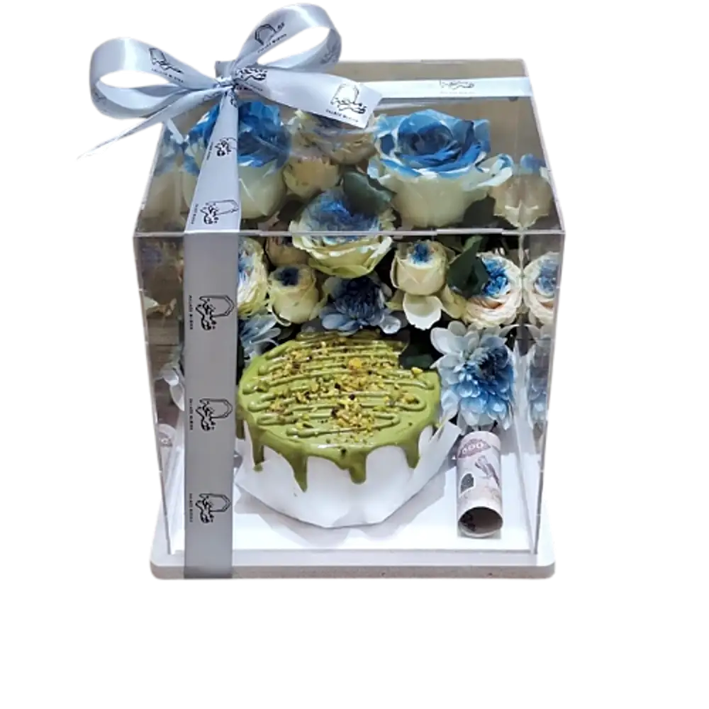 Pistachio cream cake with blue roses in a transparent box