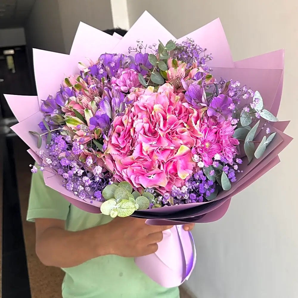 Assorted roses bouquet with purple wrapping
