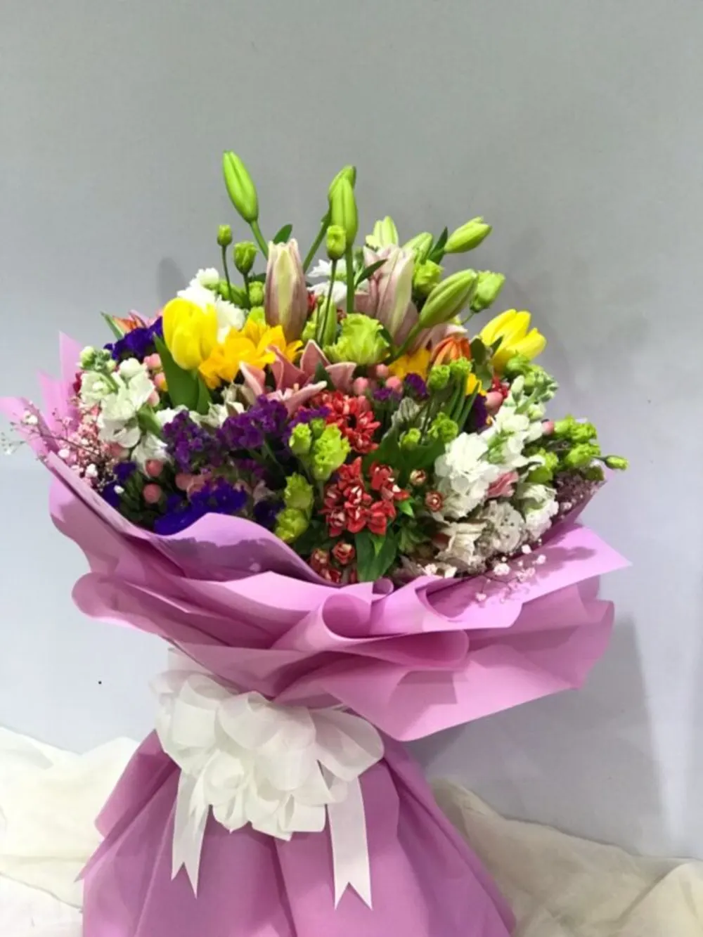 Mixed bouquet with light purple wrapper