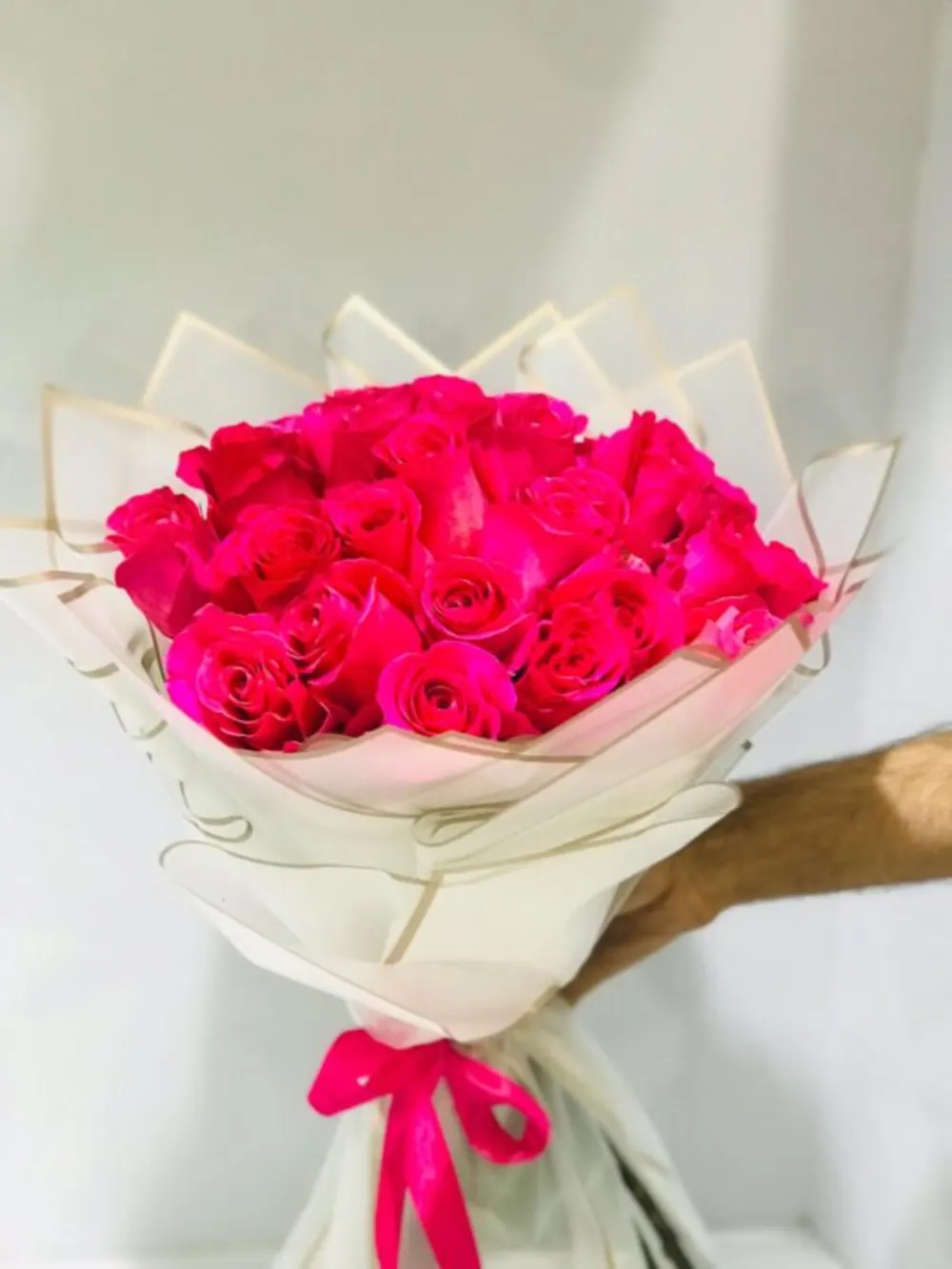 Fuchsia roses bouquet wrapped in white paper N