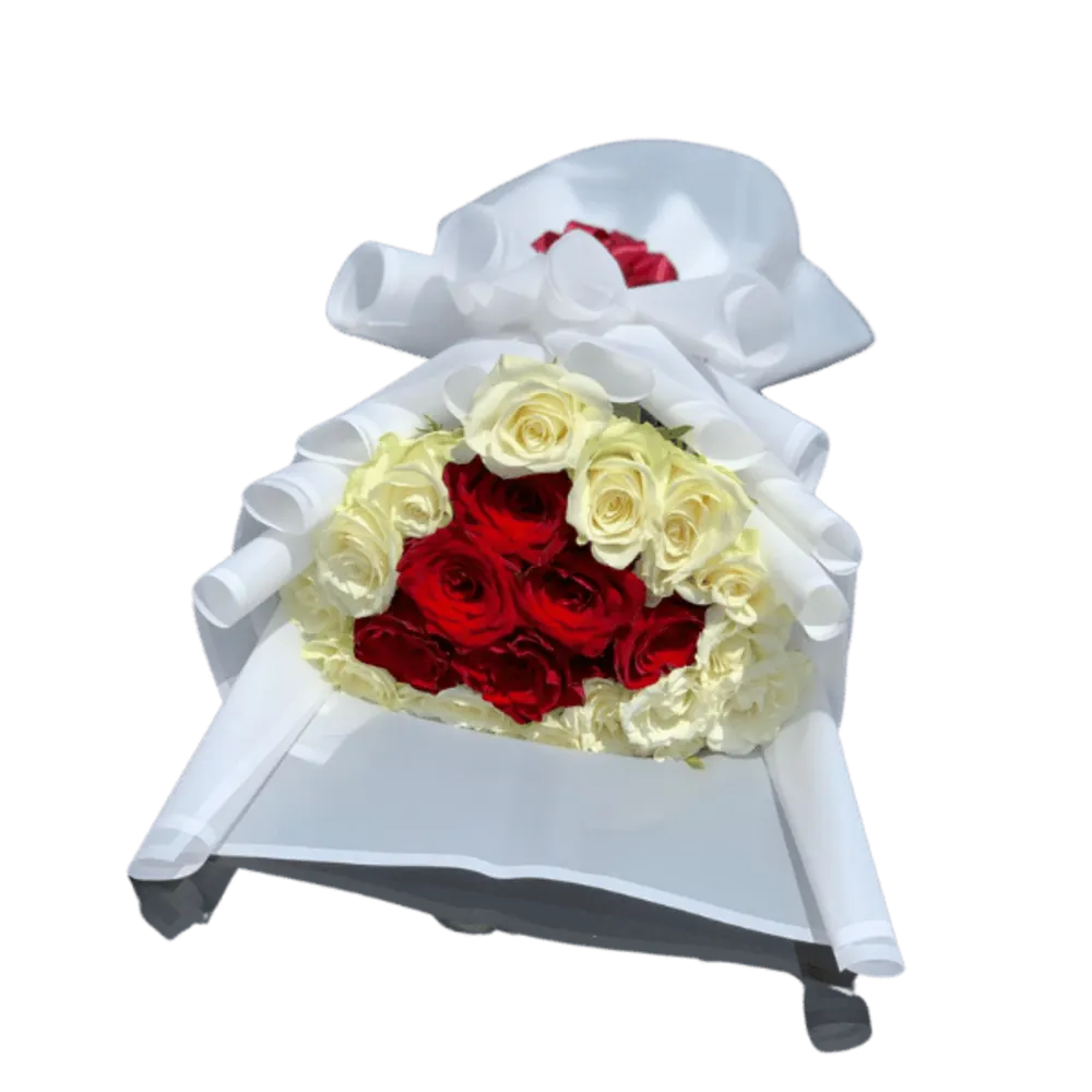 A bouquet of white and red roses with a white cover