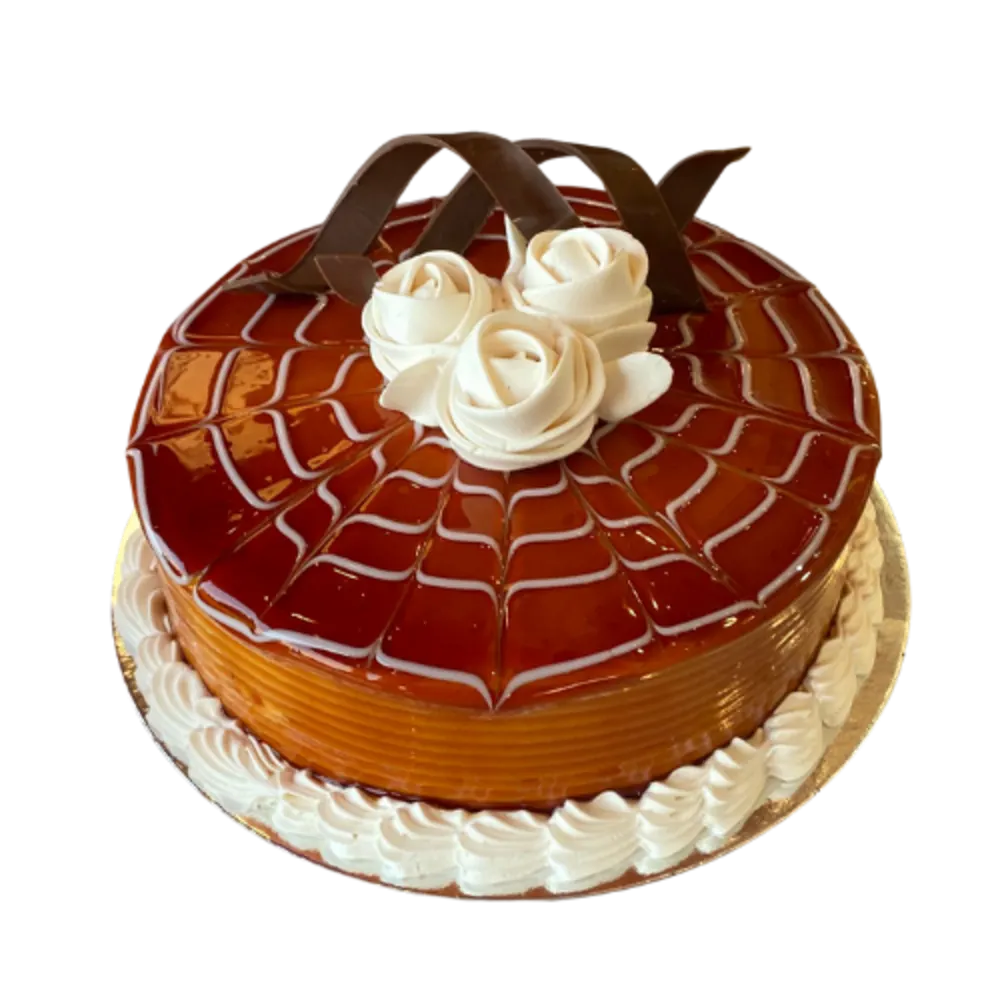 Chocolate and caramel cake decorated with cream
