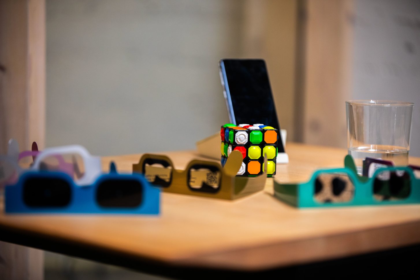 Ein Tisch mit einem Handy, einem taktilen Zauberwirfel und mehreren Simulationsbrillen zu Sehbehinderungen / Bildquelle: Lumen & Letter