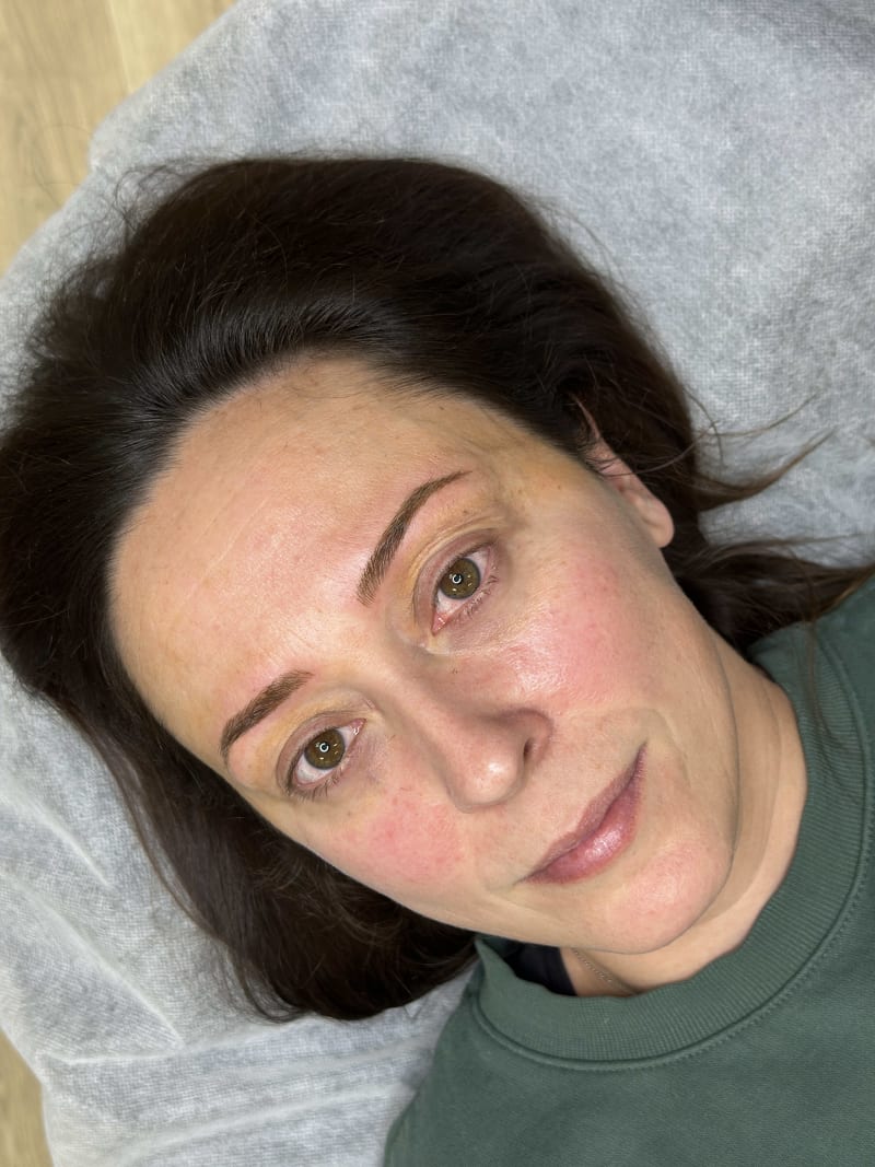 Client showing healed natural microblading result at Nirvana PMU — the test of skill is how brows look at 6 weeks healed