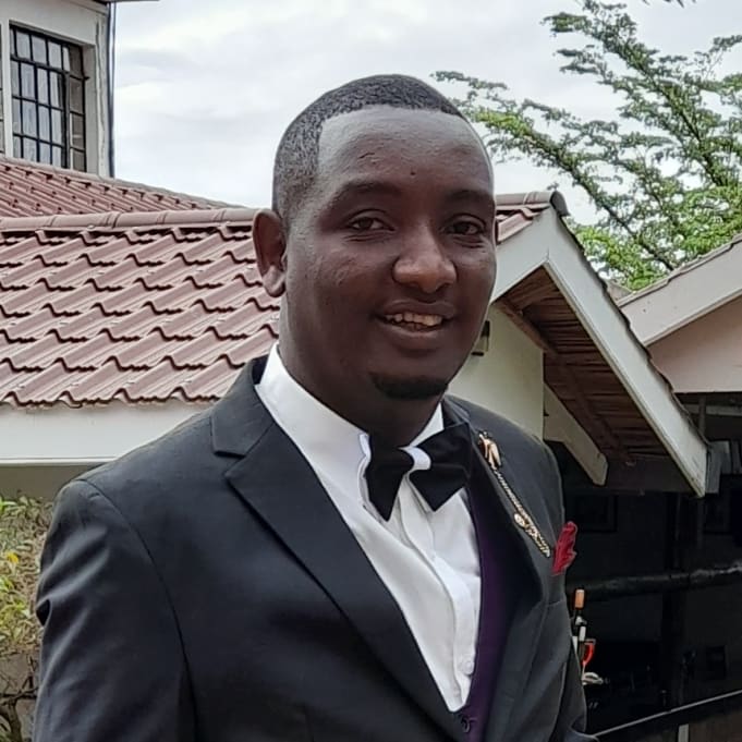 a man in a pink suit sitting at a table
