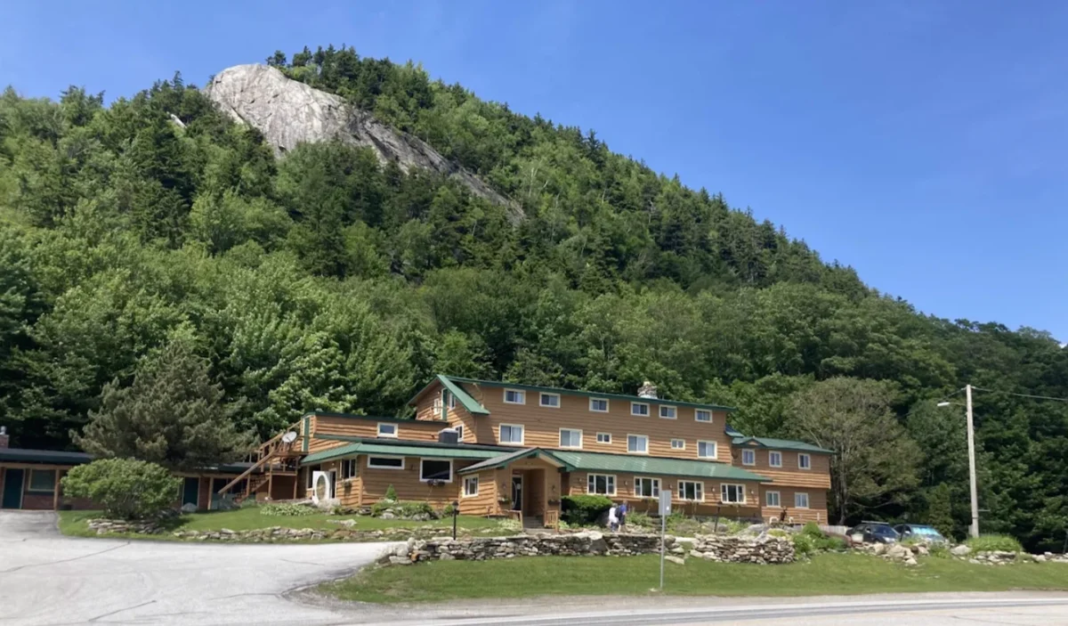 The inn in summer beneath the cliffs