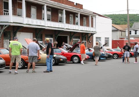 Xenon stepped in to host the White Rose car show with cars parked diagonally in front of the brick shop building