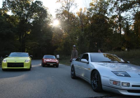 The New 2023 Z Proto Spec (in Ikazuchi Yellow Pearl TriCoat) posing with the most significant forebearers that inspired the new design: an orange Series 1 240Z, and a silver Z32 300ZX