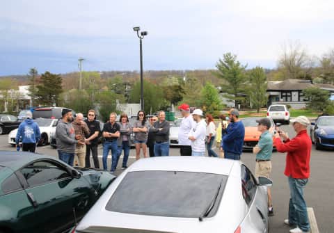 The owner of a dark green 350Z talks to the Z club members about their journey in modifying their car.