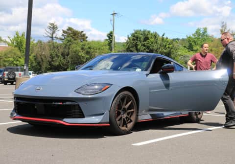 A gray New Z Nismo graces our meet sporting black wheels, the extended nose, and a red stripe around the front spoiler, side skirts and lower rear bumper.