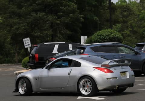 A silver 300ZX with wide custom rims from Japan, sporting a 2 level rear spoiler.
