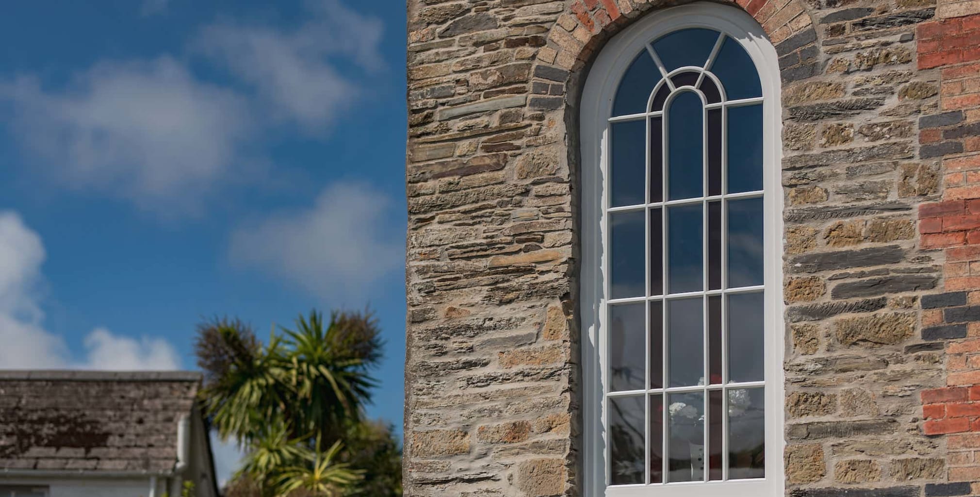 chapel glass external half view with blue sky | NMC